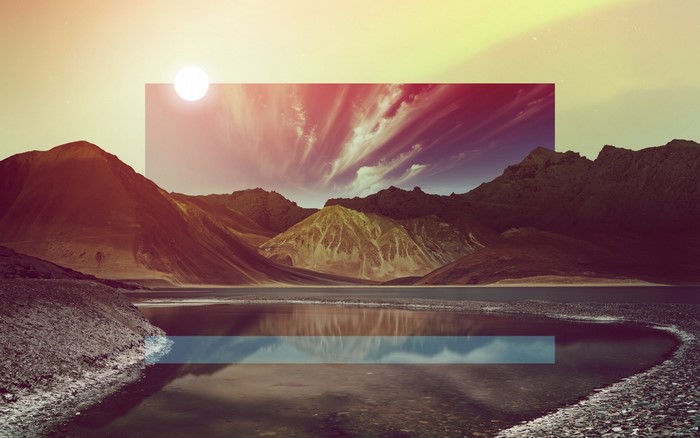 Mountains and lake with sun and sky reflection