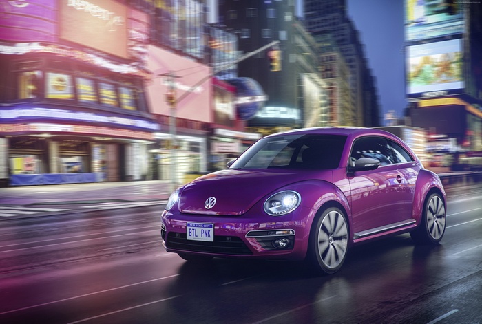 Purple Volkswagen Beetle driving in New York City at night