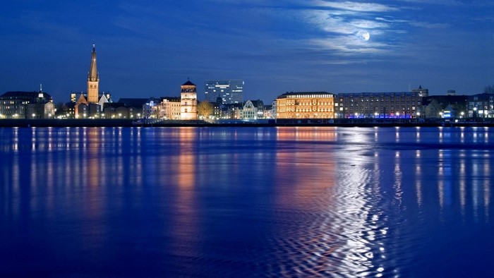 City skyline reflected in water at night