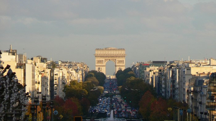 Arc de Triomphe and Paris cityscape at dusk