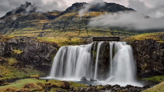 Waterfall cascading down a rocky mountain in Iceland