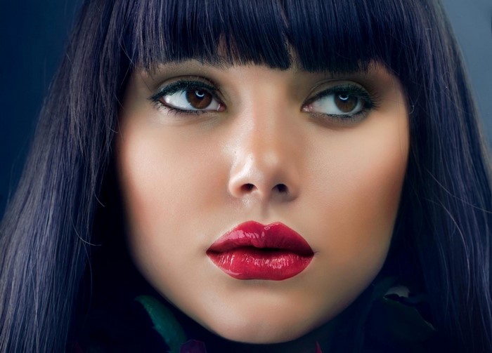Close up portrait of a woman with black hair and red lips