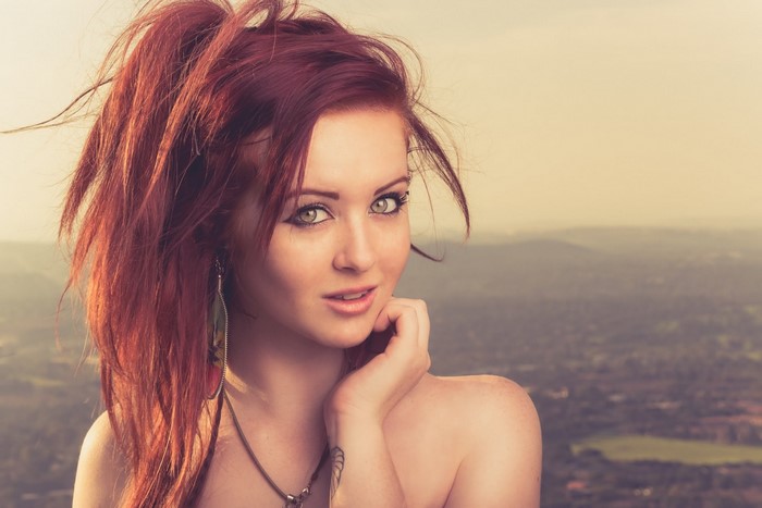 Portrait of Redhead Woman with Long Hair and Tattoo