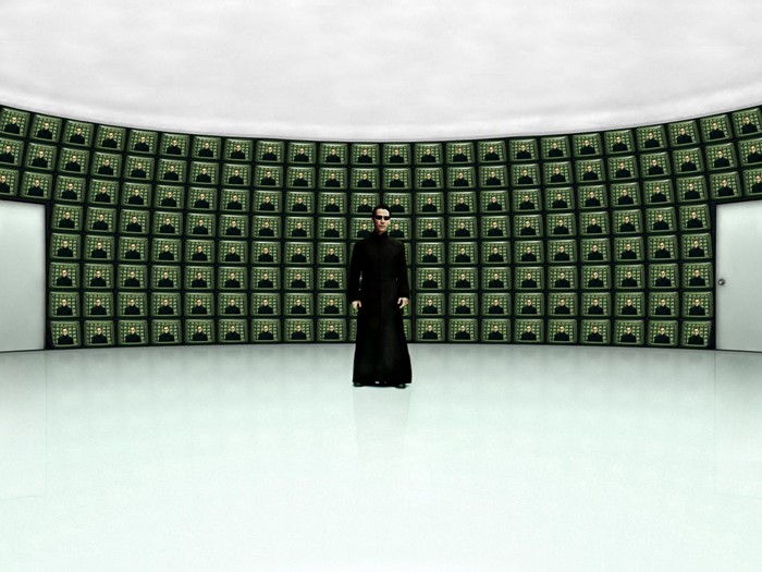 Neo from The Matrix Reloaded in a room with monitors