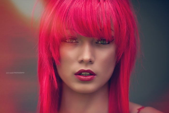 Woman with bright pink dyed hair and red lipstick