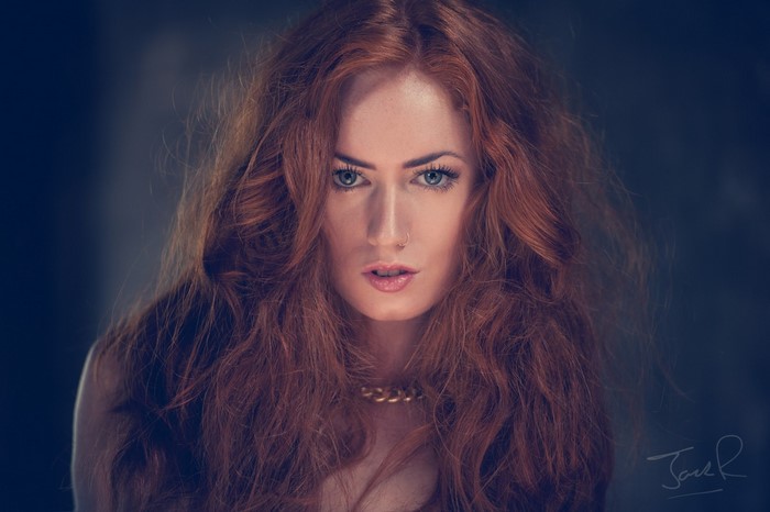 Woman with long red hair and blue eyes