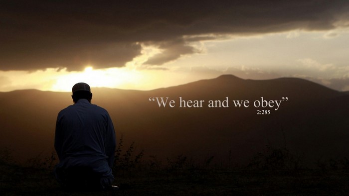 Man praying at sunset with Quran verse