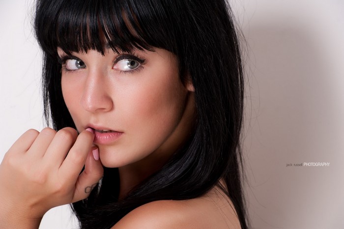 Close-up Portrait of Woman with Black Hair and Bangs