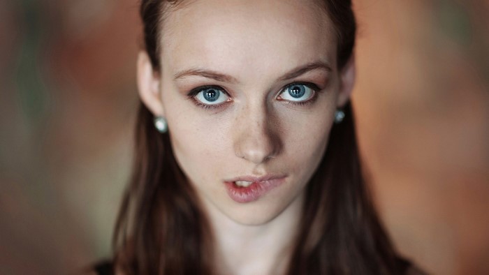 Woman with blue eyes biting her lip