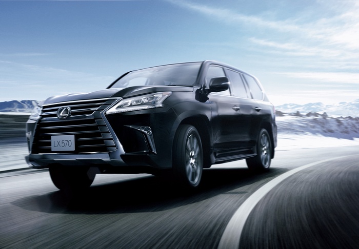 Black Lexus LX 570 driving on a snowy road