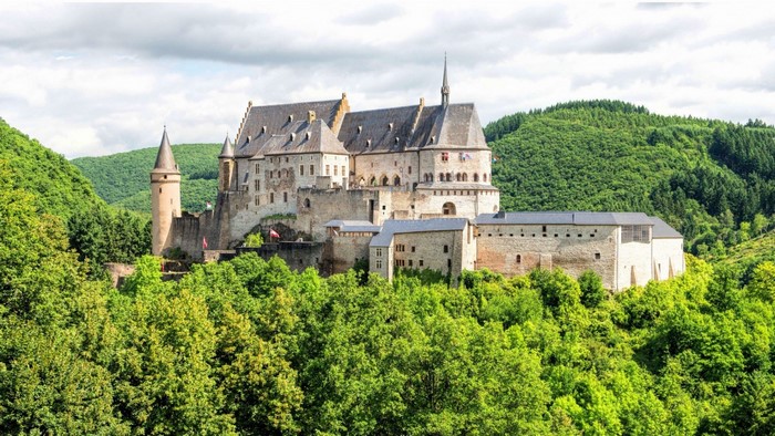 Vianden Castle surrounded by green hills and trees