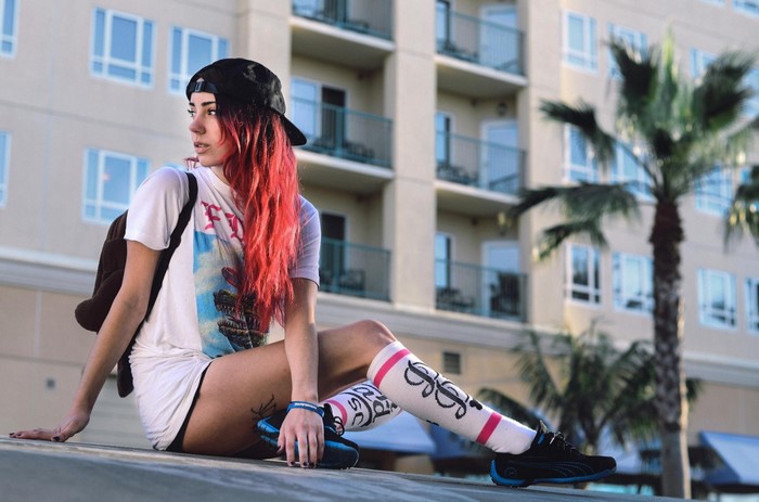 Woman with red hair wearing a t-shirt and socks