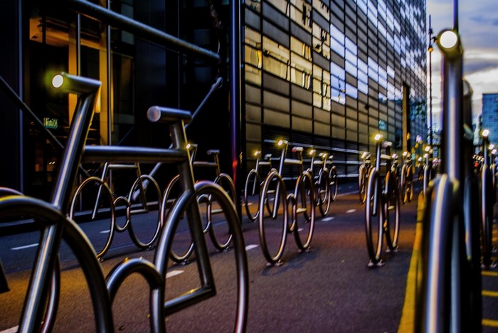 Street at night with bicycle racks and modern building