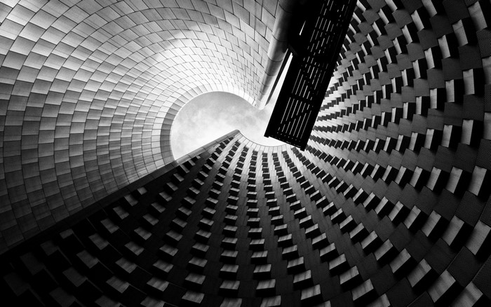 Monochrome worm's eye view of modern architecture with spiral design