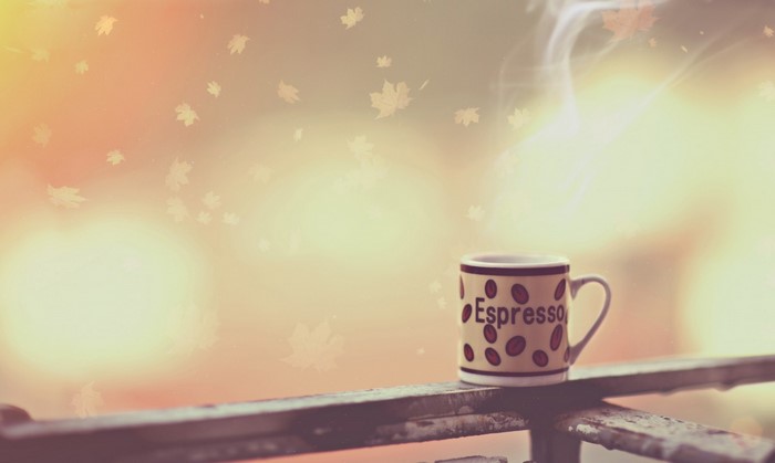 Espresso cup with steam and falling leaves