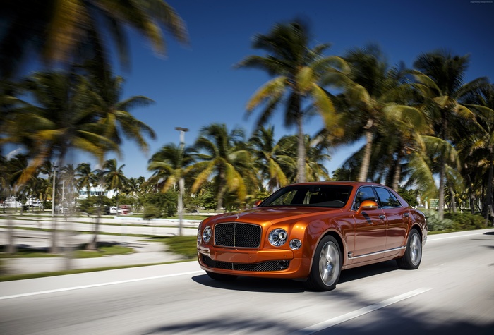 Orange Bentley Mulsanne driving on a sunny day
