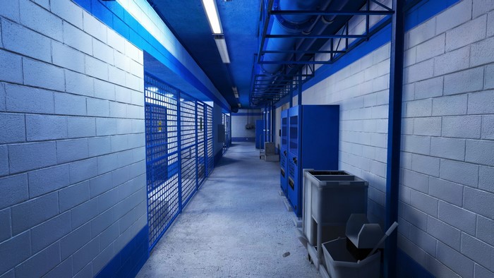 Hallway with blue cages and vending machines