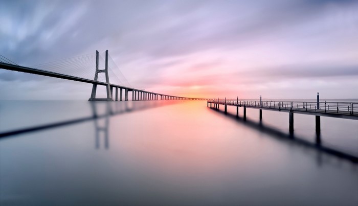 Vasco da Gama Bridge and pier at sunset, Lisbon, Portugal