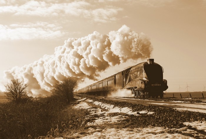 Steam locomotive train in sepia tone with snow