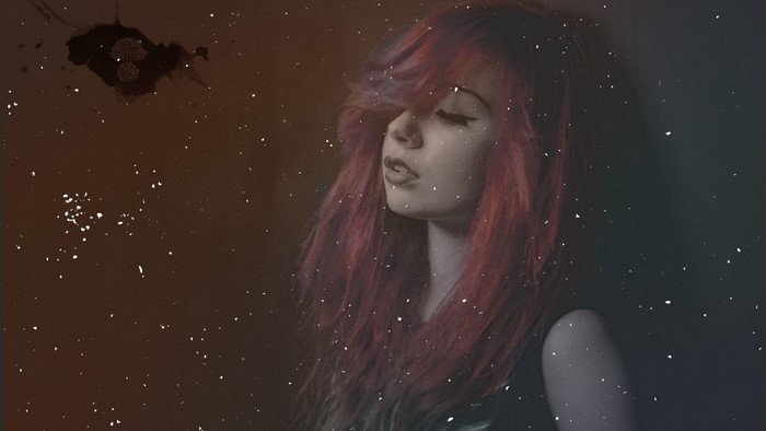 Woman with red hair and dark background