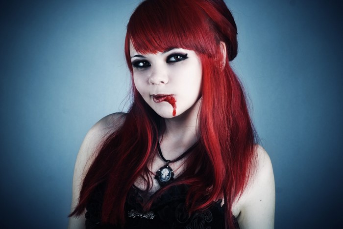 Goth girl with red hair and fake blood