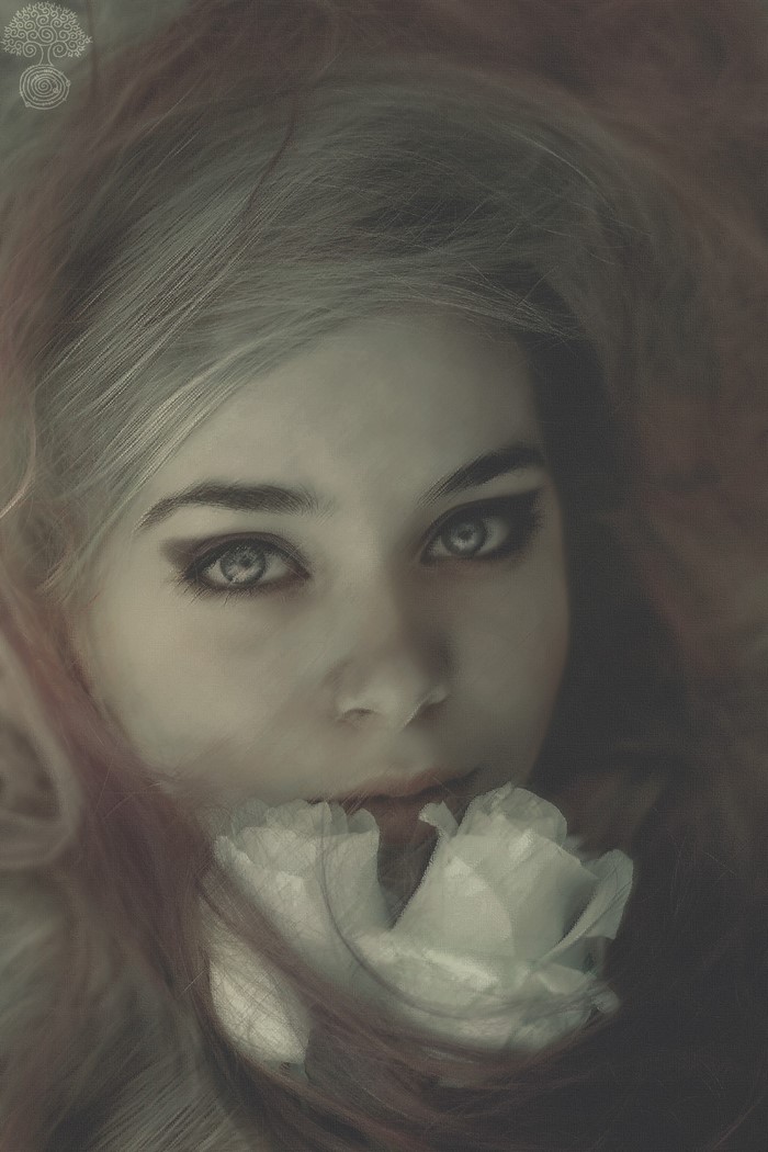 Close up portrait of a woman with a white flower