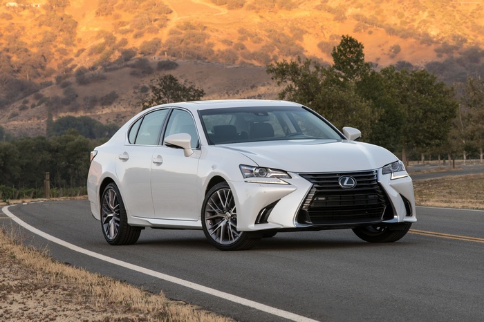 White Lexus GS350 sedan on a winding road