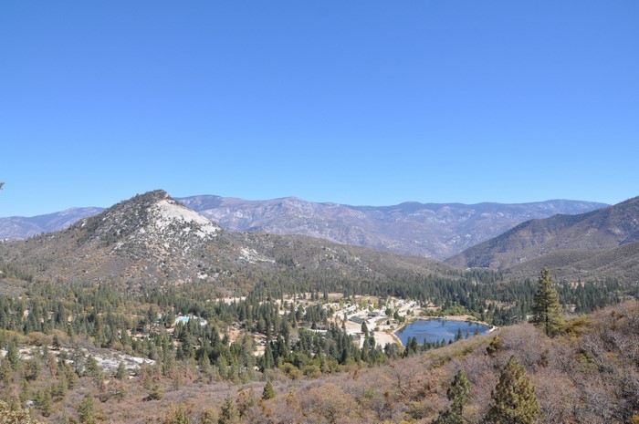 Mountain valley with a lake and forested hills