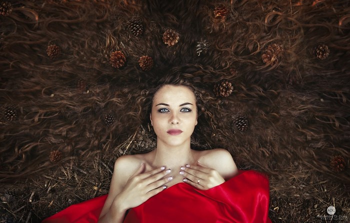 Woman with long hair and pinecones