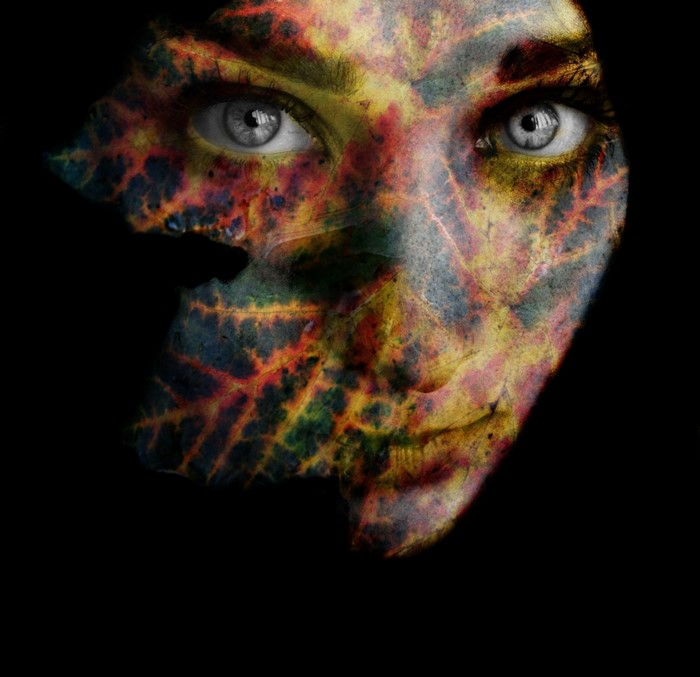 Woman's face with leaf pattern overlay