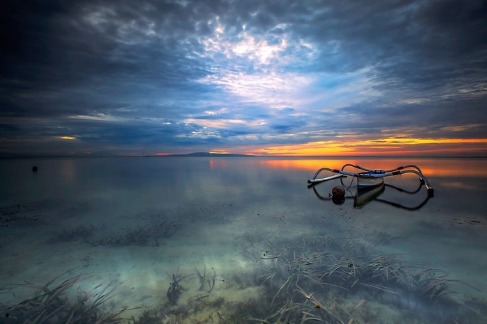Sunset over a calm sea with a snorkel mask