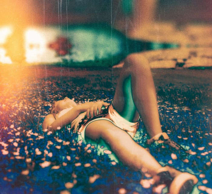 Woman lying in a field of flowers