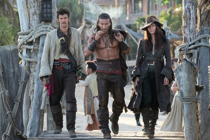Three pirates walking on a wooden pier
