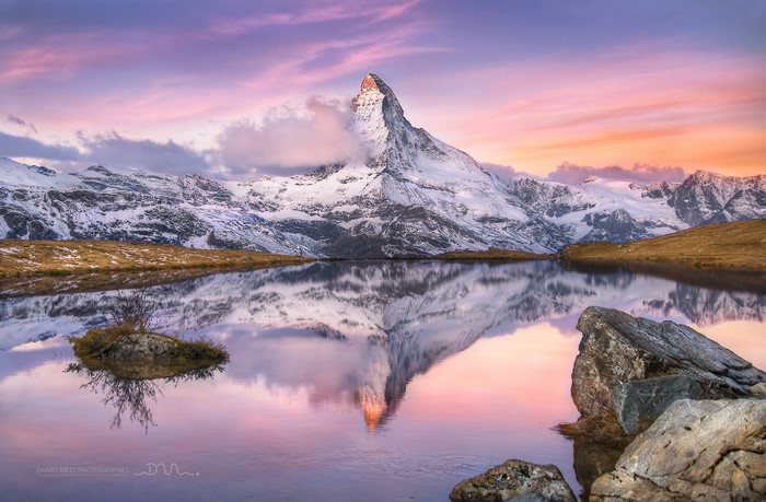 Matterhorn mountain reflected in a lake at sunset