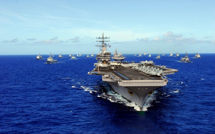 Aircraft carrier and naval fleet at sea