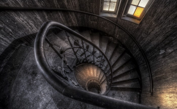 Dark Spiral Staircase Interior with Window Light
