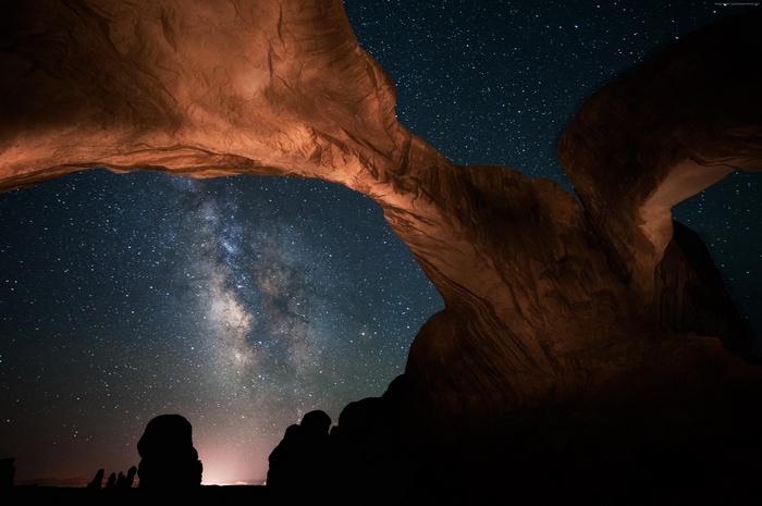 Milky Way galaxy seen through rock arch at night