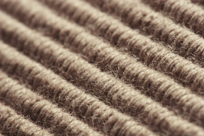 Close-up of brown ribbed carpet texture