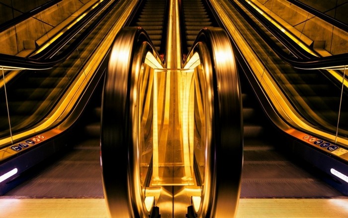 Golden escalator with yellow lights and depth of field