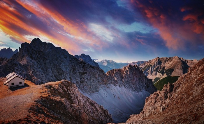Mountain range with a cottage at sunset
