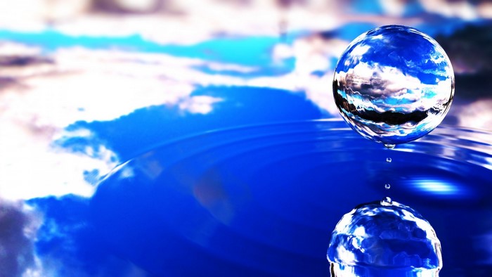 Water sphere reflecting sky and clouds on water surface
