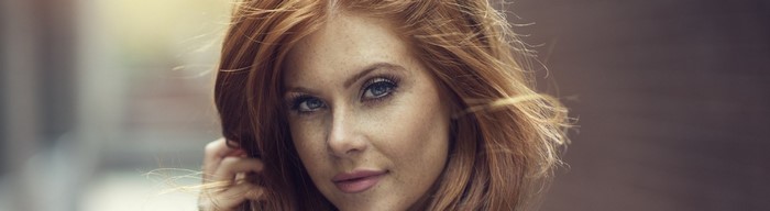 Redhead woman with blue eyes and freckles