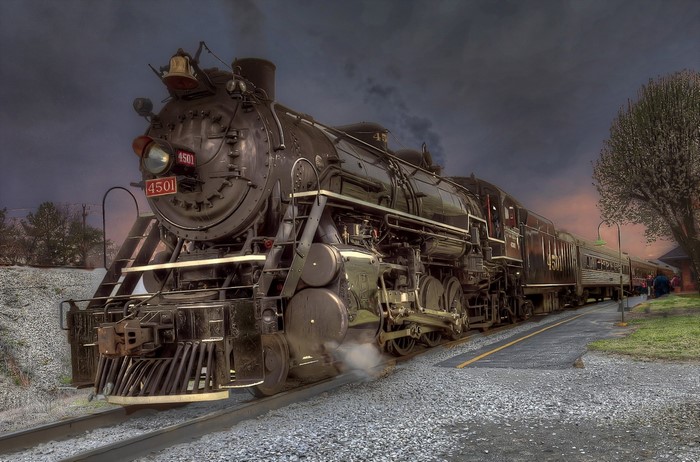 Vintage Steam Locomotive on Railway Track at Dusk