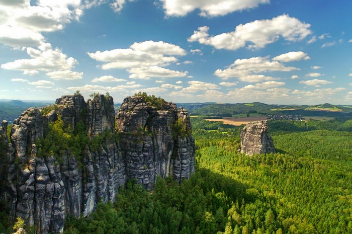 Majestic Rocky Cliffs Above Dense Green Forest