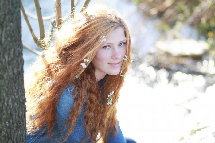 Redhead Woman with Flowers in Hair in Sunlight
