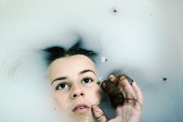 Woman with flowers in milk bath