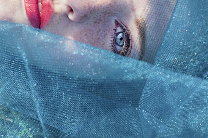 Close up of a woman's face with blue veil