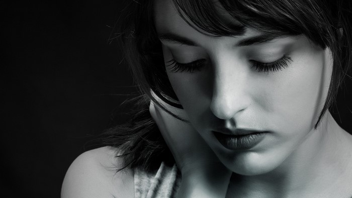 Monochrome portrait of a woman looking down