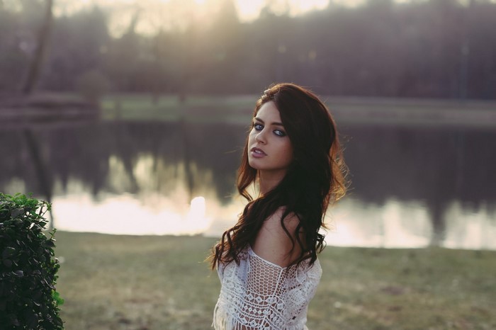 Woman with Brown Hair in Sunlit Outdoor Setting