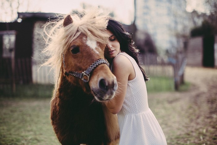 Woman hugging a horse